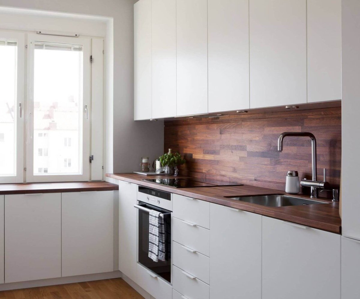 Белая кухня со столешницей под дерево